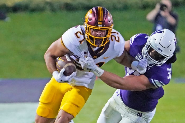 Sep 23, 2023; Evanston, Illinois, USA; Minnesota Golden Gophers running back Bryce Williams (21) tries to run past Northwestern Wildcats linebacker Bryce Gallagher (32) during the first quarter at Ryan Field.